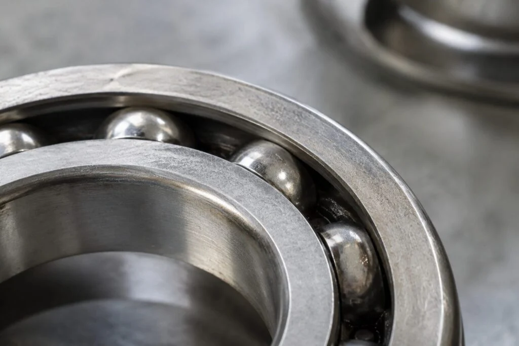 Close-up of the laser-etched marking on the outer ring of a used roller bearing