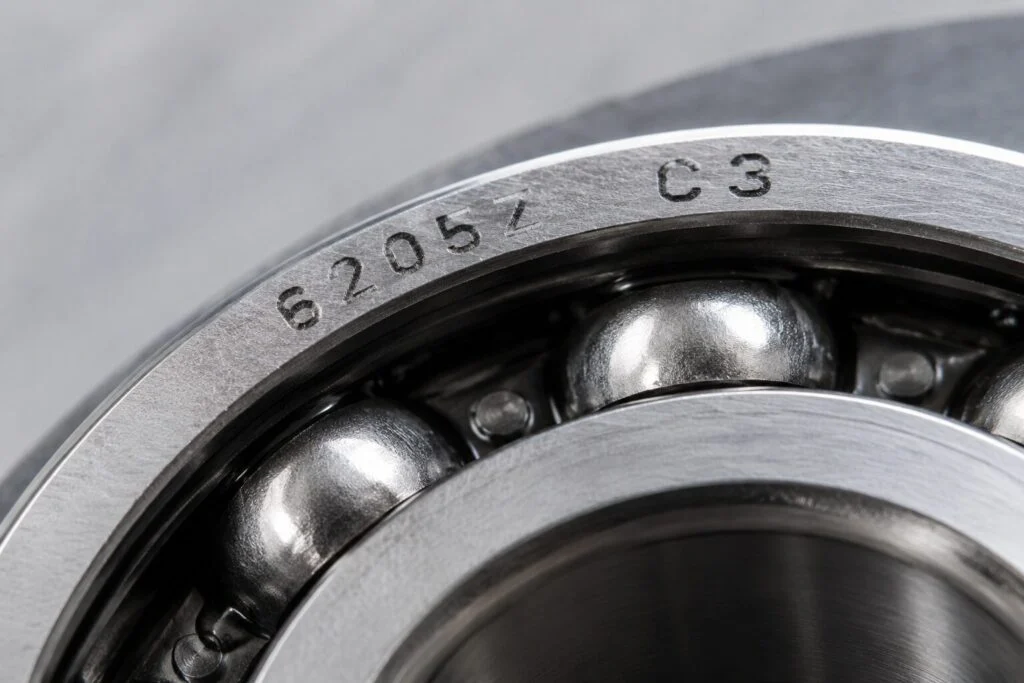 Macro view of engraved characters on the outer ring of a steel bearing